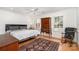 Bedroom with hardwood floors, a ceiling fan, a rocking chair, and bright natural light at 2825 Sharon View Rd, Charlotte, NC 28210