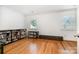 Bedroom with hardwood floors, base trim, natural light, and built-in bookshelves at 2825 Sharon View Rd, Charlotte, NC 28210