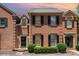 Charming brick townhouse with black shutters and landscaped front yard at 2825 Sharon View Rd, Charlotte, NC 28210