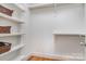 Walk-in closet with white shelves, hardwood floor, and white walls at 2825 Sharon View Rd, Charlotte, NC 28210