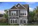 Charming two-story home boasts a symmetrical design, complemented by gray siding, and white trimmed windows at 3103 Middle St # 92, Charlotte, NC 28278