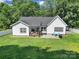 An aerial view showcasing a well-maintained backyard with a stone patio and a lush green lawn at 333 Anne Ave, Waxhaw, NC 28173