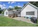 A charming backyard featuring a stone patio, a covered wooden deck, and a lush green lawn at 333 Anne Ave, Waxhaw, NC 28173