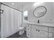 Bright bathroom with white vanity, modern finishes, a round mirror, and a shower tub combination at 333 Anne Ave, Waxhaw, NC 28173