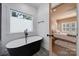 Bathroom featuring a modern stand alone tub next to a window for natural light at 333 Anne Ave, Waxhaw, NC 28173