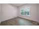 An empty room with neutral walls and a large window providing natural light at 333 Anne Ave, Waxhaw, NC 28173