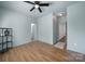 Bedroom with connecting bathroom, dark wood floors, and bright blue walls at 333 Anne Ave, Waxhaw, NC 28173