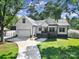 Charming home exterior featuring a covered front porch, well-manicured lawn, and attached garage at 333 Anne Ave, Waxhaw, NC 28173