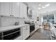Modern kitchen with white cabinetry, subway tile backsplash, stainless steel appliances, and a sleek countertop at 333 Anne Ave, Waxhaw, NC 28173