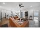 Spacious living room with open floor plan, featuring a large brown leather sofa, modern fixtures, and hardwood floors at 333 Anne Ave, Waxhaw, NC 28173
