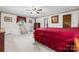 Cozy bedroom with a red comforter, traditional furniture, and natural light at 36433 Azalea Cir, New London, NC 28127