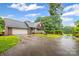 Well-manicured front lawn and driveway leading to a two-car garage attached to the brick home at 36433 Azalea Cir, New London, NC 28127