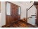 Home entryway with wooden door, hardwood floors, and staircase with white railing at 36433 Azalea Cir, New London, NC 28127