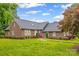 Charming brick home featuring a well-manicured lawn, mature trees, and a classic architectural design at 36433 Azalea Cir, New London, NC 28127