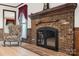 Elegant brick fireplace with decorative mantle and vintage accents, perfect for cozy evenings at 36433 Azalea Cir, New London, NC 28127
