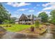 Charming brick and shingle home with a well-maintained front yard and covered porch at 36433 Azalea Cir, New London, NC 28127