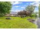 Brick house with mature trees and a well-manicured lawn on a cloudy day at 36433 Azalea Cir, New London, NC 28127
