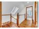 Open hallway featuring beautiful hardwood floors and access to a bedroom at 36433 Azalea Cir, New London, NC 28127