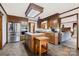 Functional kitchen featuring stainless steel appliances, wooden cabinetry, and center island with butcher block at 36433 Azalea Cir, New London, NC 28127