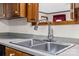 Stainless steel double kitchen sink with modern faucet and gray countertops at 36433 Azalea Cir, New London, NC 28127