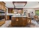 Well-equipped kitchen with central island cooktop, stainless appliances, and dining area at 36433 Azalea Cir, New London, NC 28127