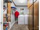 Functional laundry room with washer, dryer, shelving, and ample storage at 36433 Azalea Cir, New London, NC 28127