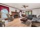 Spacious living room featuring a brick fireplace, comfortable seating, and natural light from the windows at 36433 Azalea Cir, New London, NC 28127