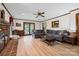 Open living room with wood accents, a large sectional sofa, and a brick fireplace at 36433 Azalea Cir, New London, NC 28127
