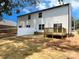 Spacious backyard with a wooden deck and a newly installed white picket fence at 3926 Litchfield Rd, Charlotte, NC 28211