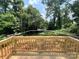 View from the wooden deck looking out at the lush backyard with mature trees at 3926 Litchfield Rd, Charlotte, NC 28211
