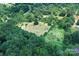 Aerial shot showing the property's vast land covered by dense, mature trees, perfect for nature enthusiasts at 4171 Leatherman Rd, Vale, NC 28168