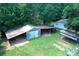 Aerial view of the barns and buildings on the treed property at 4171 Leatherman Rd, Vale, NC 28168