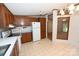 Charming kitchen featuring wood cabinets, white appliances, and eat in area at 4171 Leatherman Rd, Vale, NC 28168