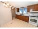 Cozy kitchen with wood cabinets, white appliances, and patterned wallpaper at 4171 Leatherman Rd, Vale, NC 28168