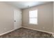 An empty bedroom features neutral walls, carpet flooring, and a window with blinds at 437 Danielle Way, Fort Mill, SC 29715