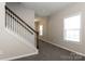 Inviting entryway featuring neutral walls, plush carpet, and a staircase with white spindles at 437 Danielle Way, Fort Mill, SC 29715