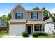 Charming two-story home with tan siding, red shutters, a garage, and a well-manicured front lawn at 437 Danielle Way, Fort Mill, SC 29715