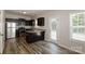 Modern kitchen with stainless steel appliances, dark cabinets, granite countertops, and wood flooring at 437 Danielle Way, Fort Mill, SC 29715