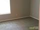 Neutral bedroom featuring plush carpeting and natural light from a window at 5855 Amity Springs Dr, Charlotte, NC 28212