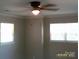Bright bedroom with two windows and a ceiling fan at 5855 Amity Springs Dr, Charlotte, NC 28212