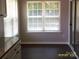 Dining space with large windows and dark wood floors, ideal for Gathering meals at 5855 Amity Springs Dr, Charlotte, NC 28212