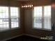 Cozy dining area with natural light from multiple windows and a contemporary light fixture at 5855 Amity Springs Dr, Charlotte, NC 28212