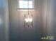 Hallway with a modern chandelier and window at 5855 Amity Springs Dr, Charlotte, NC 28212