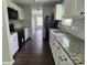 Bright kitchen featuring white cabinets, granite countertops, and stainless steel appliances at 5855 Amity Springs Dr, Charlotte, NC 28212