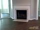 Bright living room features a marble fireplace and dark wood flooring, a cozy focal point at 5855 Amity Springs Dr, Charlotte, NC 28212