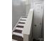 A view of the staircase with hardwood treads and white risers and handrail at 5855 Amity Springs Dr, Charlotte, NC 28212
