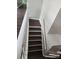 A view of the staircase with hardwood treads and white risers and handrail at 5855 Amity Springs Dr, Charlotte, NC 28212