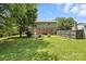 Spacious backyard featuring green grass, patio, and a fence at 6319 Welford Rd, Charlotte, NC 28211