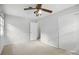Neutral bedroom featuring a ceiling fan and closet at 6319 Welford Rd, Charlotte, NC 28211