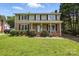 Charming two-story home with brick facade, well-manicured lawn, and inviting front porch at 6319 Welford Rd, Charlotte, NC 28211